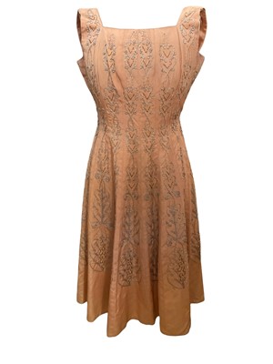 Lot 2587 - 1950s peach 'fit and flare' cocktail dress with twisted braid and spangle embroidery. Plus a 1950's black velvet flock swing skirt.