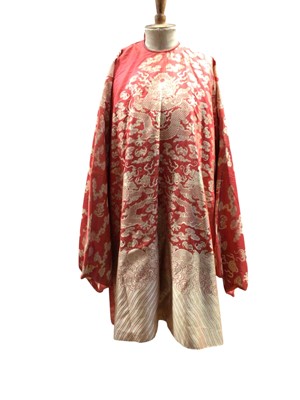 Lot 2589 - 19th century women's hand stitched Chinese red brocade dragon robe. Wide sleeves, 10 dragons with 5 claws, bats, waves and clouds.