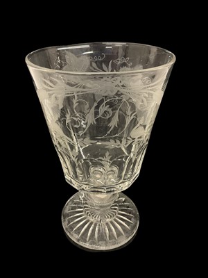 Lot 56 - Large 19th century glass rummer with slice cut and engraved decoration, the stem set with a silver coin dated 1812, 25cm in overall height.