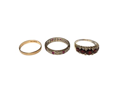 Lot 139 - 9ct gold wedding ring, 9ct gold gem set eternity ring and a yellow metal garnet five stone ring (3)