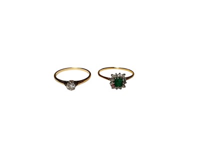 Lot 143 - Diamond single stone ring in yellow metal setting and an emerald and diamond cluster ring in yellow metal setting (2)