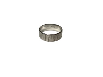 Lot 146 - 1970s platinum thick band wedding ring with carved line decoration