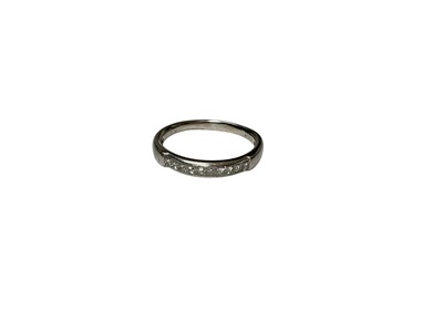Lot 148 - Platinum diamond half eternity ring with ten princess cut diamonds in a channel setting