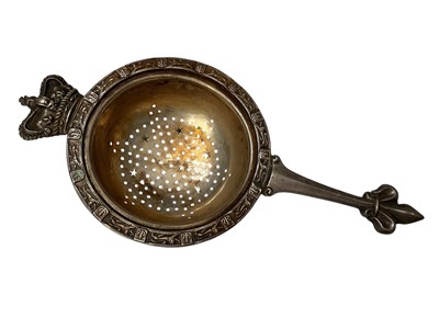 Lot 129 - 1930s Royal Coronation themed silver tea strainer (Birmingham 1936), maker Adie Brothers, 14cm in length.