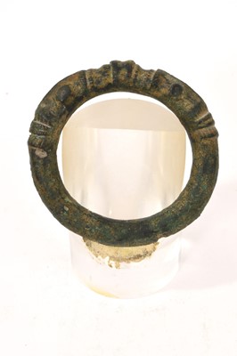 Lot 704 - Viking bronze armlet, moulded with conjoined beasts, on stand