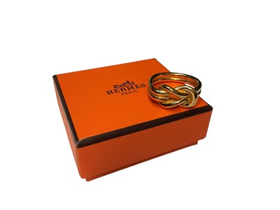 Lot 108 - Hermès gold-plated knot ring, size U, in original box