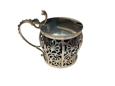 Lot 93 - 1920s silver mustard pot with ornate pierced decoration and blue glass liner (Birmingham 1923)