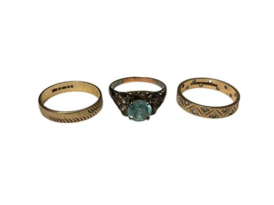 Lot 116 - Two 9ct gold wedding rings and a single stone blue zircon ring in a yellow and white metal setting (3)