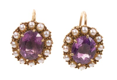 Lot 480 - Pair of amethyst and cultured pearl earrings with an oval mixed cut amethyst surrounded by a border of cultured pearls in 9ct gold gold setting with