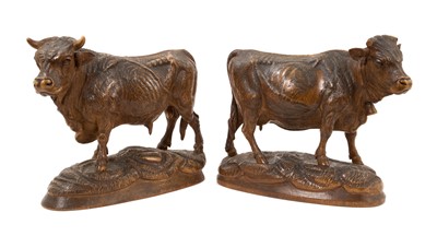 Lot 769 - Pair of 19th century Black Forest carved lindenwood models of cows