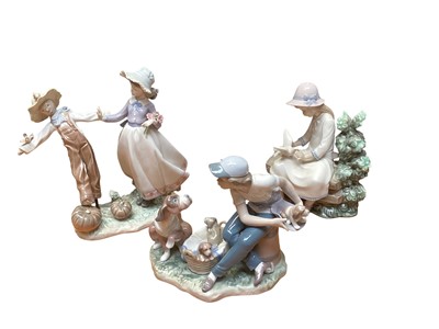 Lot 2229 - Two Lladro and one Nao porcelain figure groups including girl with scarecrow, boy with dogs and seated girl with doves