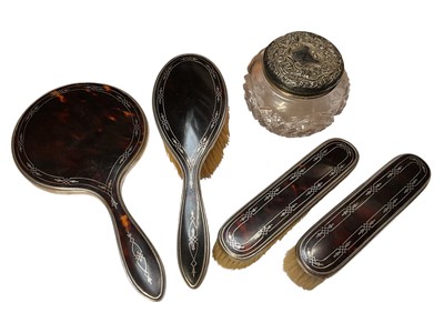 Lot 269 - George V silver and tortoiseshell four pieces dressing table set, (Birmingham 1920), together with a silver topped dressing table pot.