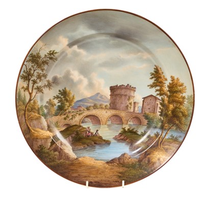 Lot 72 - 19th century Berlin porcelain charger, painted with a river landscape