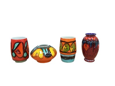 Lot 2265 - Three Poole pottery Volcano vases, together with a Delphis vase, tallest is 17.5cm high