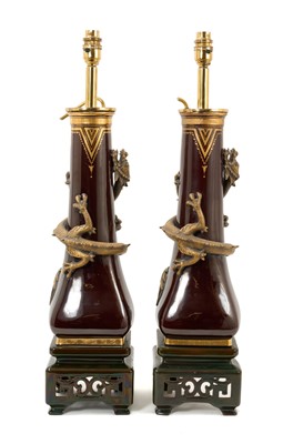 Lot 22 - Pair of Minton Aesthetic pottery vases, converted to lamps, late 19th century, in the Chinese style with applied gilt dragon around a burgundy and gilt jewelled ground on a pierced square foot,...