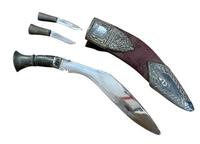 Lot 904 - Old Gurkha kukri with carved horn hilt, in velvet covered scabbard with ornate applied silver mounts, the blade 24cm in overall length.