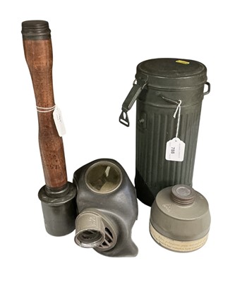 Lot 788 - Second World War German gas mask in case, together with a turned wood and metal replica stick grenade, (2).