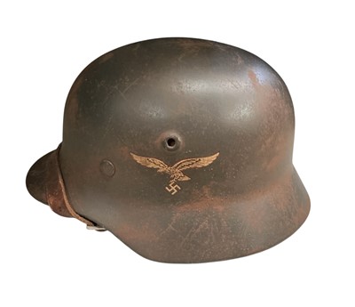 Lot 786 - Second World War Nazi German Luftwaffe M40 pattern steel helmet, with painted finish and single decal, stamped under brim 'Q64, DN257' with tan leather liner and chin strap.