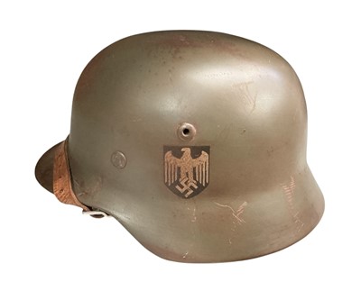 Lot 785 - Second World War Nazi German Wehrmacht M40 pattern steel helmet, with painted finish and single decal, stamped under brim 'SE64', with tan leather liner and chin strap.