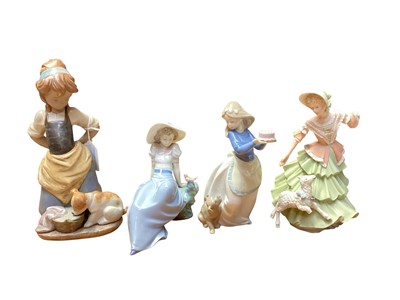Lot 2303 - Lladro figure of a girl with a dog, together with two NAO figures and a Wedgwood figure (4)