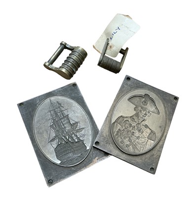 Lot 782 - Two 19th century bronze printers' plates depicting Nelson and his flagship Victory, each 8 x 6cm, together with two combination padlocks, (4).