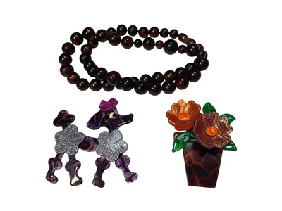 Lot 175 - Two vintage Lea Stein brooches - poodle and flower pot, together with a vintage simulated amber necklace