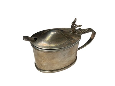 Lot 123 - George V silver mustard pot of oval form, with blue glass liner, (Chester 1917), 9cm in overall length.