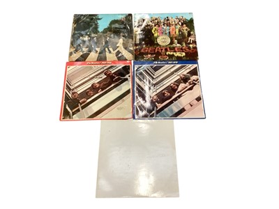 Lot 2709 - Five Beatles vinyl records including Abbey Road, Sgt Pepper's Lonely Hearts Club Band, 1962-1966, 1967-1970 and The Beatles White album with four photos
