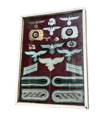 Lot 732 - Group of Nazi German Luftwaffe and Wehrmacht cloth and metal badges, mounted in a glazed frame.
