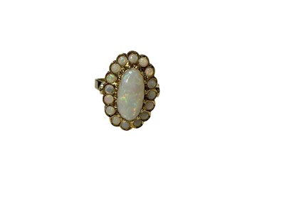 Lot 234 - Contemporary 14ct gold opal cluster ring with a central oval opal cabochon surrounded by a border of sixteen further opals in a 14ct gold setting (Edinburgh 2021), size O