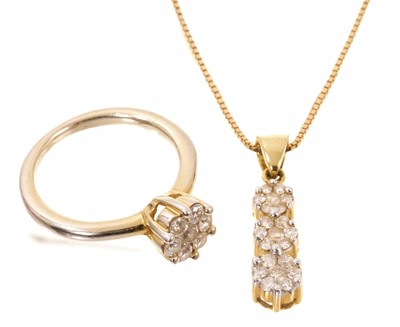 Lot 424 - Diamond flower head cluster ring and matching necklace