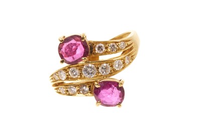 Lot 417 - Ruby and diamond cross over ring in yellow metal setting