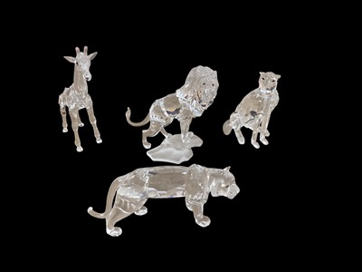 Lot 2320 - Four Swarovski Crystal animals including Lion, Giraffe, Tiger and Cheetah, all boxed