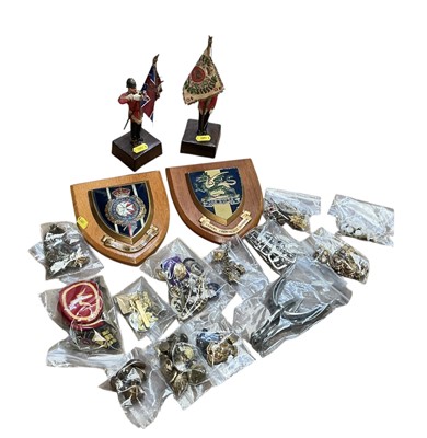 Lot 753 - Collection of British military cap badges to include Artists Rifles, The Buffs and others, together with two regimental plaques and a pair of figures holding regimental colours.