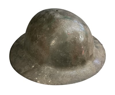 Lot 759 - First World War British MK1 steel helmet with camouflage painted finish, lining and chin strap.