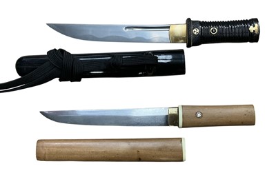 Lot 932 - Two good quality Japanese Tanto daggers, one with ribbed black lacquered fittings, the other with ivory mounted wooden mounts (2)