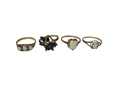Lot 259 - Four 9ct gold gem set rings to include a sapphire cluster, opal three stone and two opal single stone rings