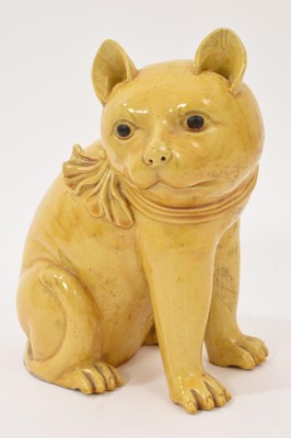 Lot 52 - Chinese yellow-glazed ceramic model of a cat in seated position with bow collar