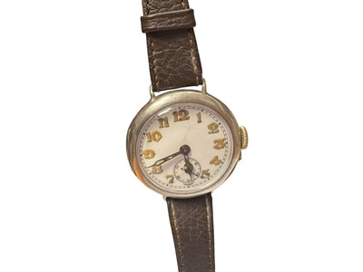 Lot 97 - First World War period silver trench wristwatch with white enamel dial, Arabic numerals and subsidiary seconds in a round silver case, 32mm diameter, on a later leather strap