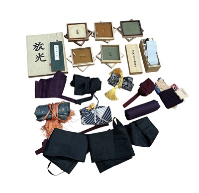 Lot 945 - Group of Japanese sword collecting accessories to include various wooden boxes for the display of Tsuba, silk sword bags, a cleaning kit and Japanese books, (1 box).