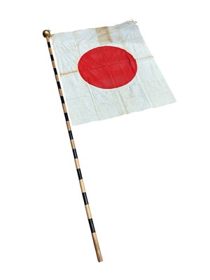 Lot 947 - Old Japanese flag, with wooden pole, the flag 85 x 67.5cm overall.