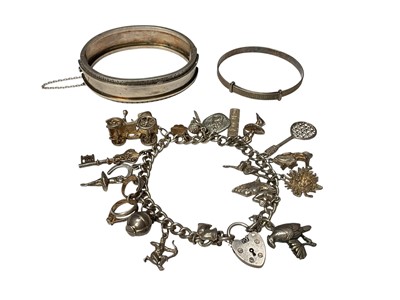 Lot 118 - Silver charm bracelet, silver christening bangle and an antique white metal hinged bangle