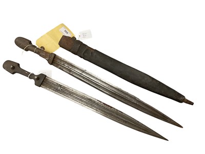 Lot 950 - Two 19th century Balkern kinjal swords with horn grips, triple fullered double edged blades with faux watered decoration , with associated leather covered sheath . The swords 55-57.5cm overall...