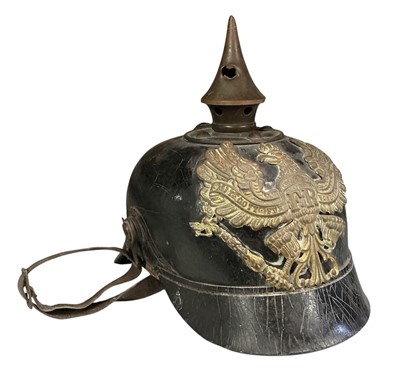 Lot 794 - First World War Imperial German Infantry man's pickelhaube with bullet hole through the spike, original gilt brass eagle helmet plate and leather liner.