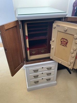Lot 1528 - Late Victorian Milners safe, the interior with fitted mahogany and velvet lined trays and mahogany lined drawers, housed in a painted oak cabinet enclosed by two panelled doors with three drawer...