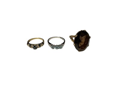 Lot 226 - 14ct gold sapphire and diamond ring, 9ct white gold gem set dress ring and a smoky quartz cocktail ring in gold setting (3)