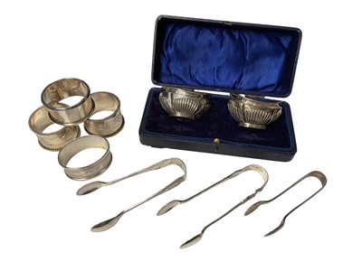 Lot 182 - Group of miscellaneous silver items to include four silver napkin rings, pair of silver salt cellars and three pairs of silver sugar tongs, (various dates and makers).