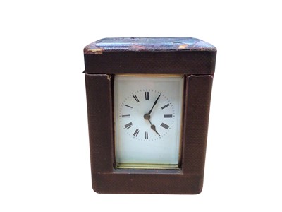 Lot 3058 - Brass carriage clock in a leather case, 12cm tall