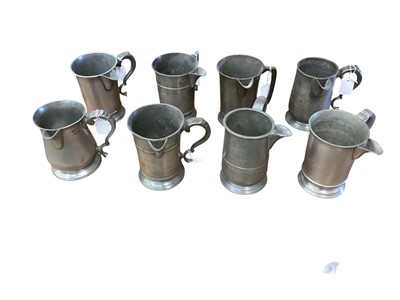Lot 3103 - Collection of eight 19th century pewter Quart tavern jugs, each with pub / tavern names engraved to bases, (8).