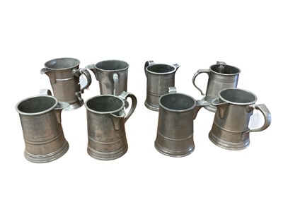 Lot 3105 - Collection of eight 19th century pewter Quart tavern jugs, each with pub / tavern names engraved to bases, (8).